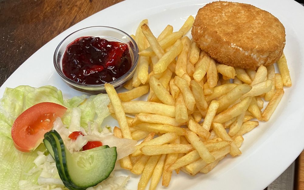 Plate with fries, breaded patty, side salad, and red sauce.