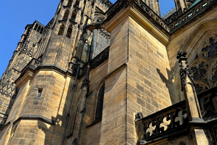 Gothic-style cathedral with ornate stone details against a clear blue sky.
