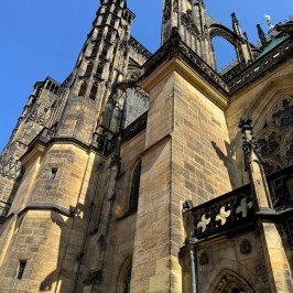Gothic-style cathedral exterior under a clear blue sky.