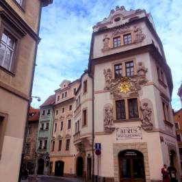Ornate European building at a street corner with blue sky.